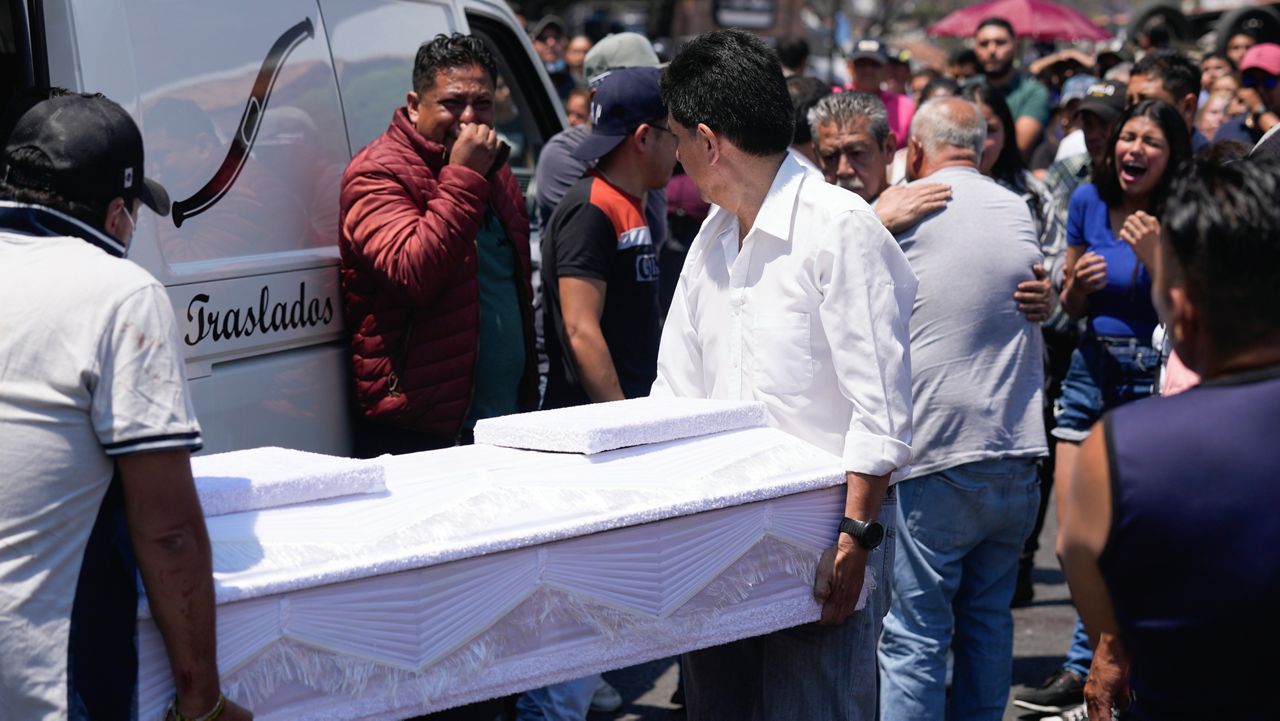 Funeral workers carry the coffin that contain the remains of an 8-year-old girl, in Taxco, Mexico, Thursday, March 28, 2024. The 8-year-old girl disappeared Wednesday; her body was found on a road on the outskirts of the city early Thursday.  (AP Photo/Fernando Llano)