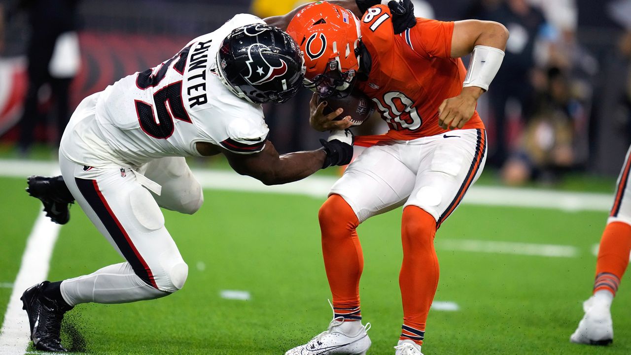 Chicago Bears quarterback Caleb Williams, right, is grabbed by Houston Texans defensive end Danielle Hunter (55) during the second half of an NFL football game Sunday, Sept. 15, 2024, in Houston. (AP Photo/Eric Christian Smith)