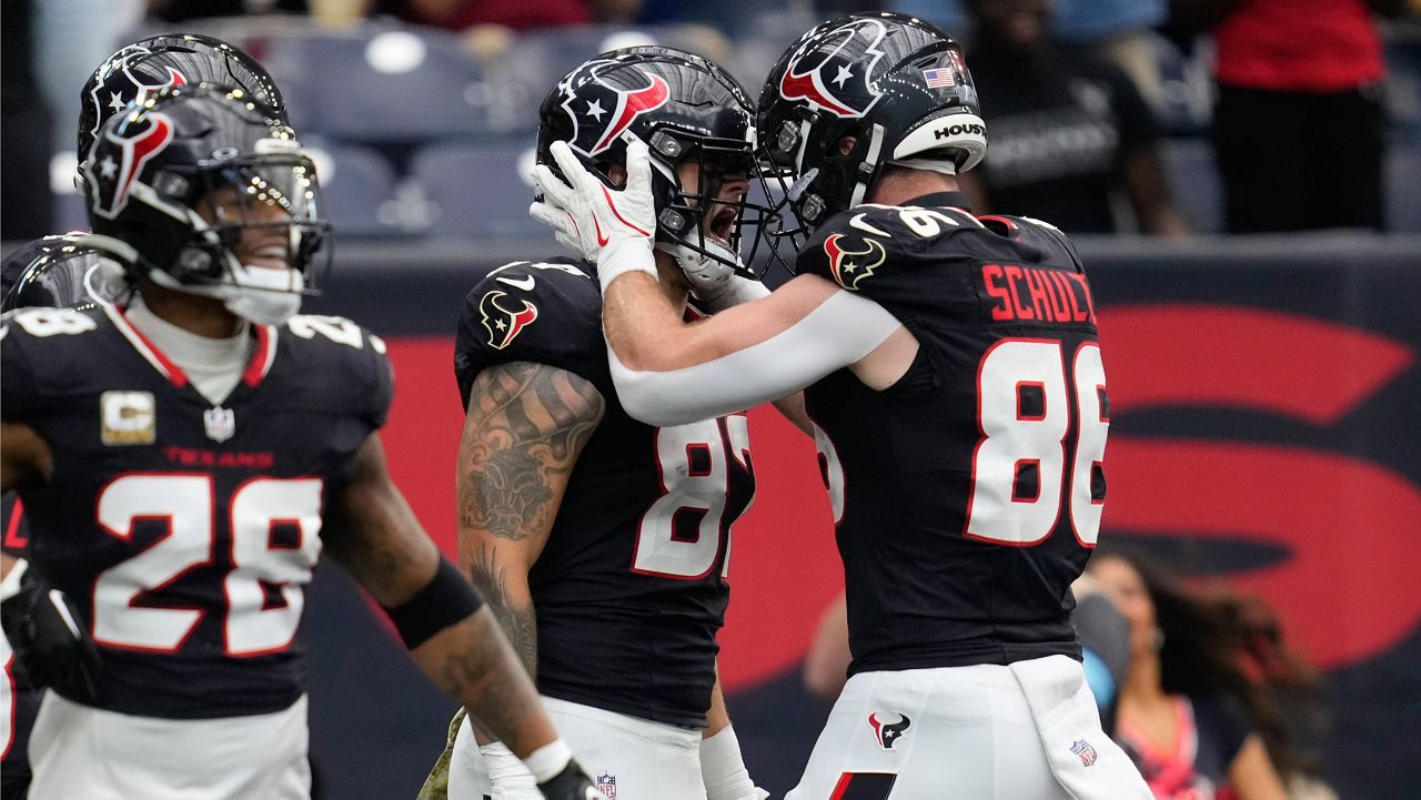 Houston Texans tight end Cade Stover, center, celebrates his touchdown with teammate Dalton Schultz (86) during the first half of an NFL football game against the Tennessee Titans, Sunday, Nov. 24, 2024, in Houston. (AP Photo/Ashley Landis)