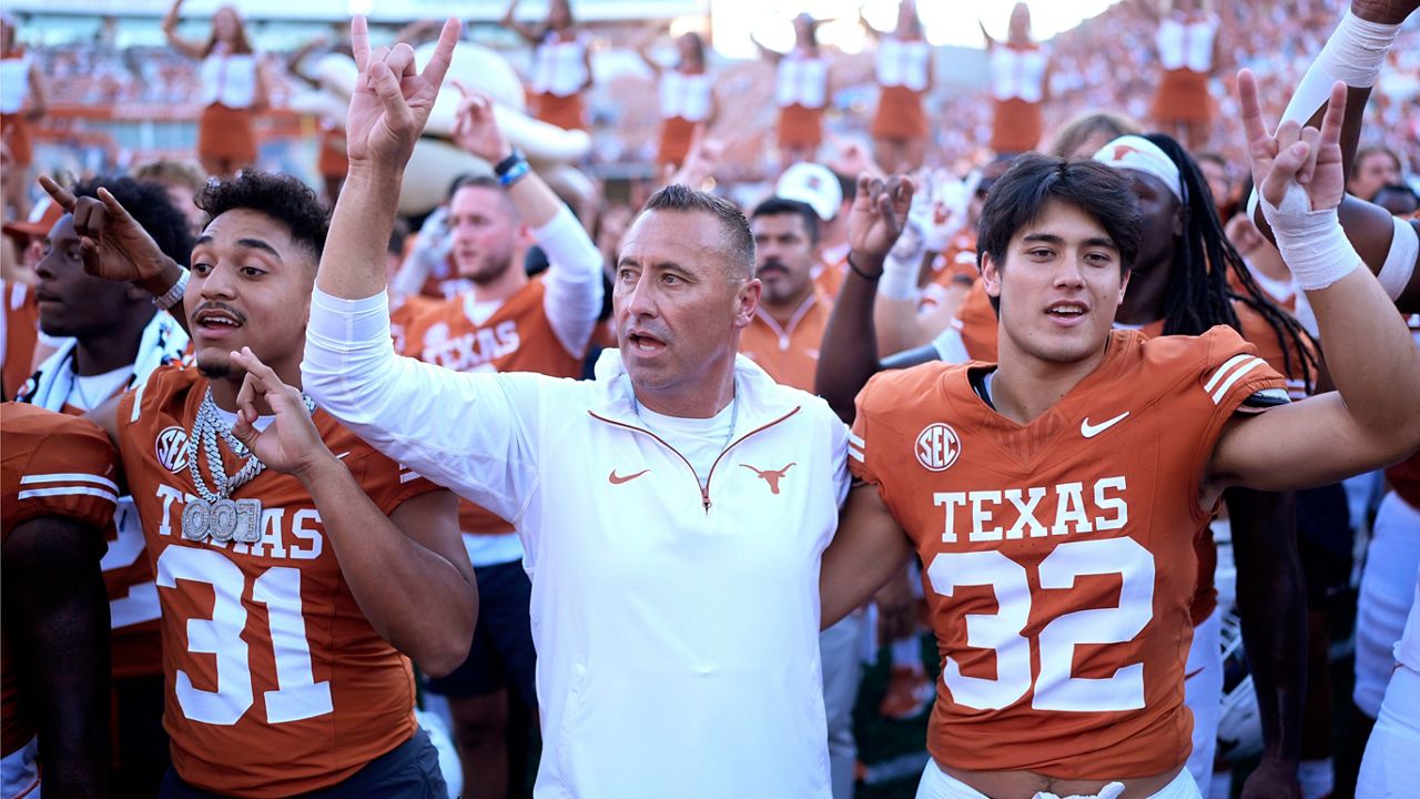 Texas head coach Steve Sarkisian, center, joins players for the school song following their win over Mississippi State in an NCAA college football game in Austin, Texas, Saturday, Sept. 28, 2024. (AP Photo/Eric Gay)