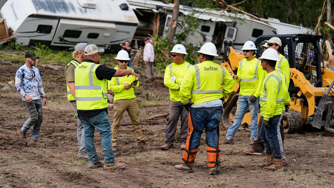 People help during clean-up efforts at Guadalupe Keys Resort, an RV park in Center Point, Texas, after flooding, Monday, July 7, 2025. (AP Photo/Ashley Landis)