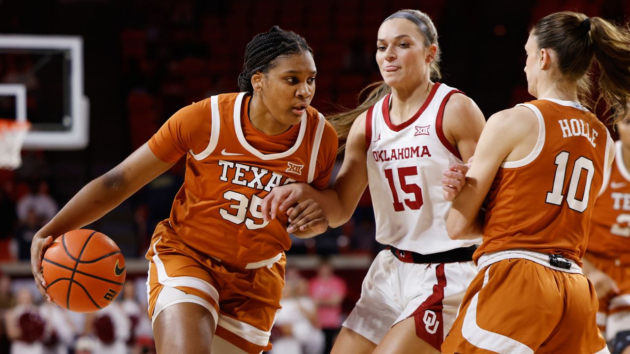 Texas forward Madison Booker (35) drives the ball against Oklahoma guard Lexy Keys (15), guarded by Texas guard Shay Holle (10), during the first half of an NCAA college basketball game Wednesday, Feb. 28, 2024, in Norman, Okla. (AP Photo/Garett Fisbeck)