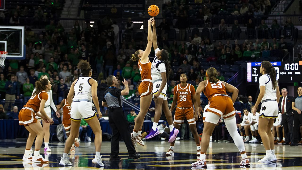 Notre Dame forward Liatu King (20) and Texas forward Taylor Jones (44) fight for the tipoff during the first half of an NCAA college basketball game Thursday, Dec. 5, 2024, in South Bend, Ind. (AP Photo/Michael Caterina)