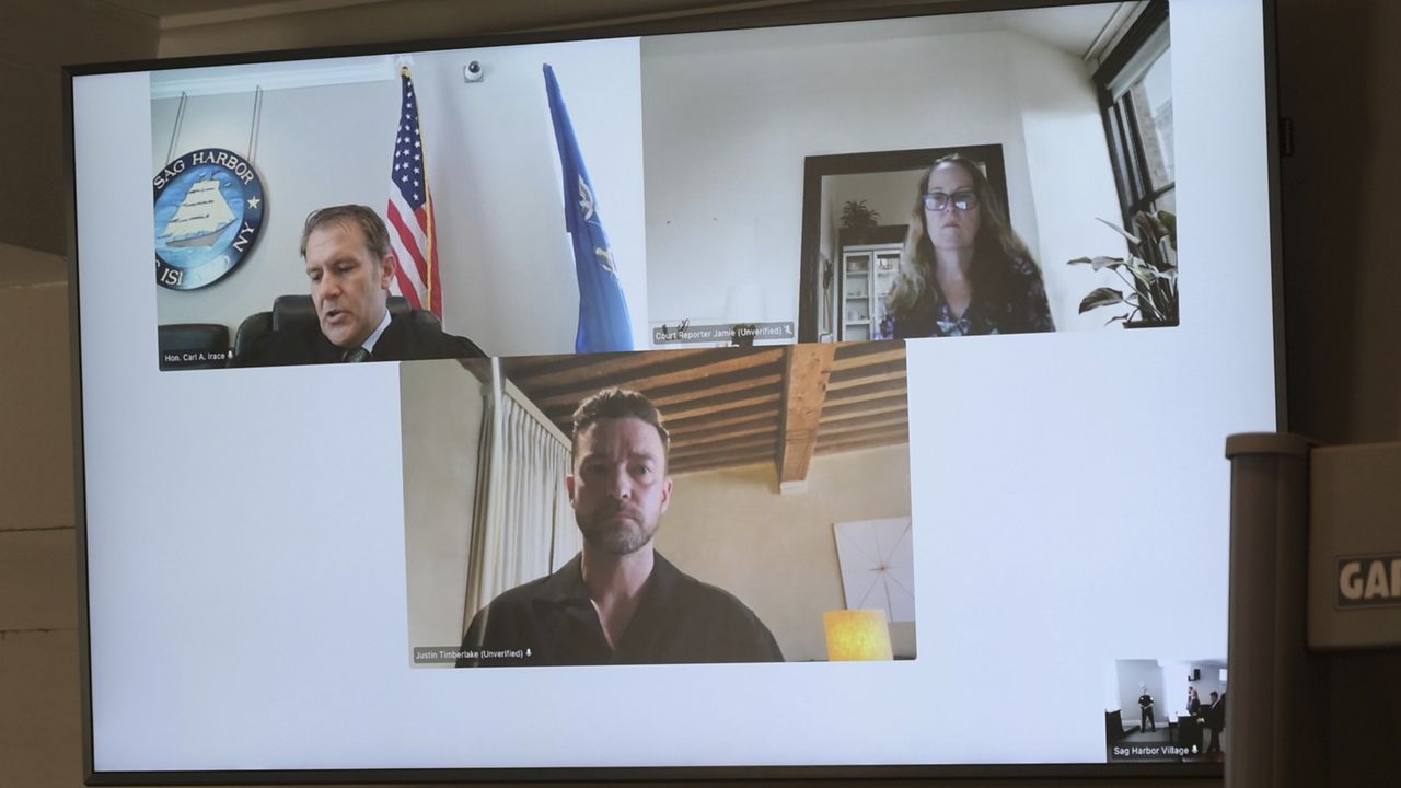 Justin Timberlake, center, appears by video during his arraignment in Sag Harbor Justice Carl Irace's courtroom on Friday, Aug. 2, 2024 in Sag Harbor, N.Y. (John Roca/Newsday via AP)