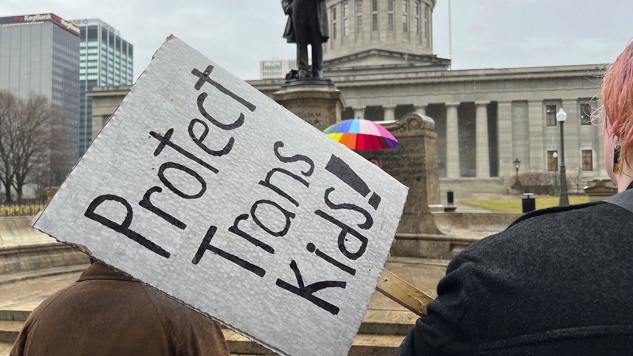 Protesters advocating for transgender rights and healthcare stand outside of the Ohio Statehouse, Jan. 24, 2024, in Columbus, Ohio. (AP Photo/Patrick Orsagost)