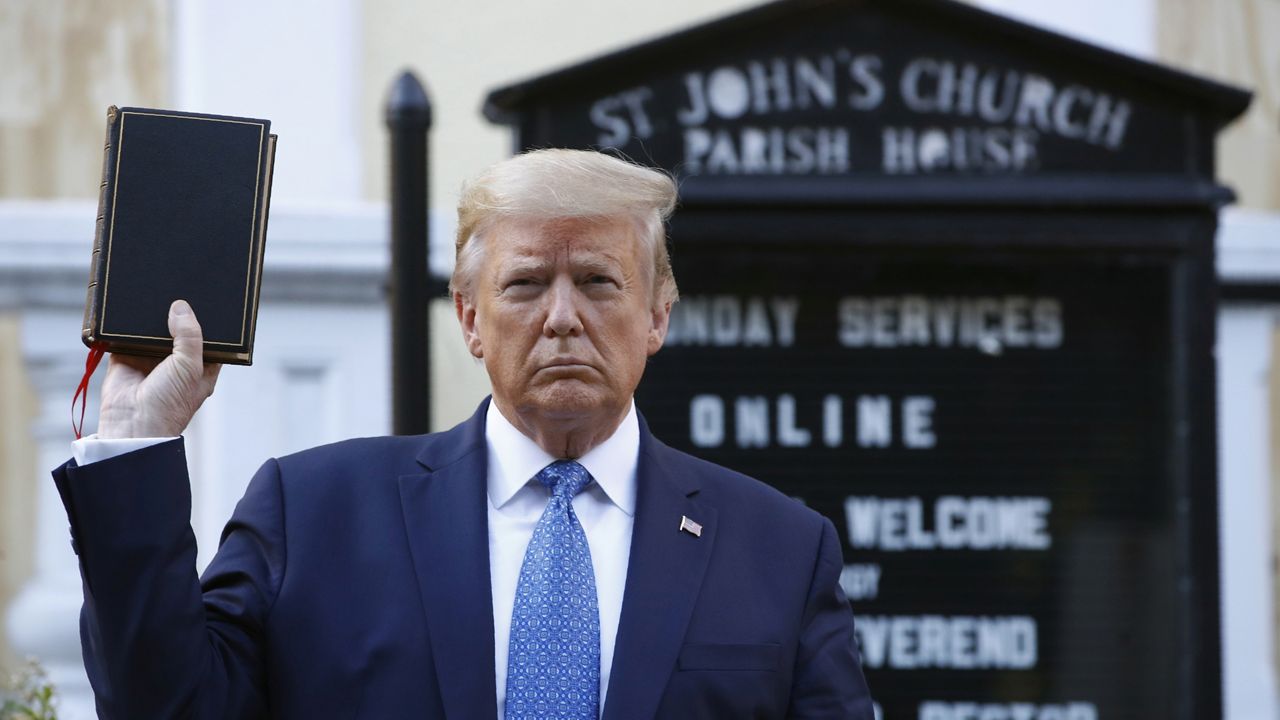 President Donald Trump holds a Bible as he visits outside St. John's Church across Lafayette Park from the White House, June 1, 2020, in Washington. (AP Photo/Patrick Semansky)