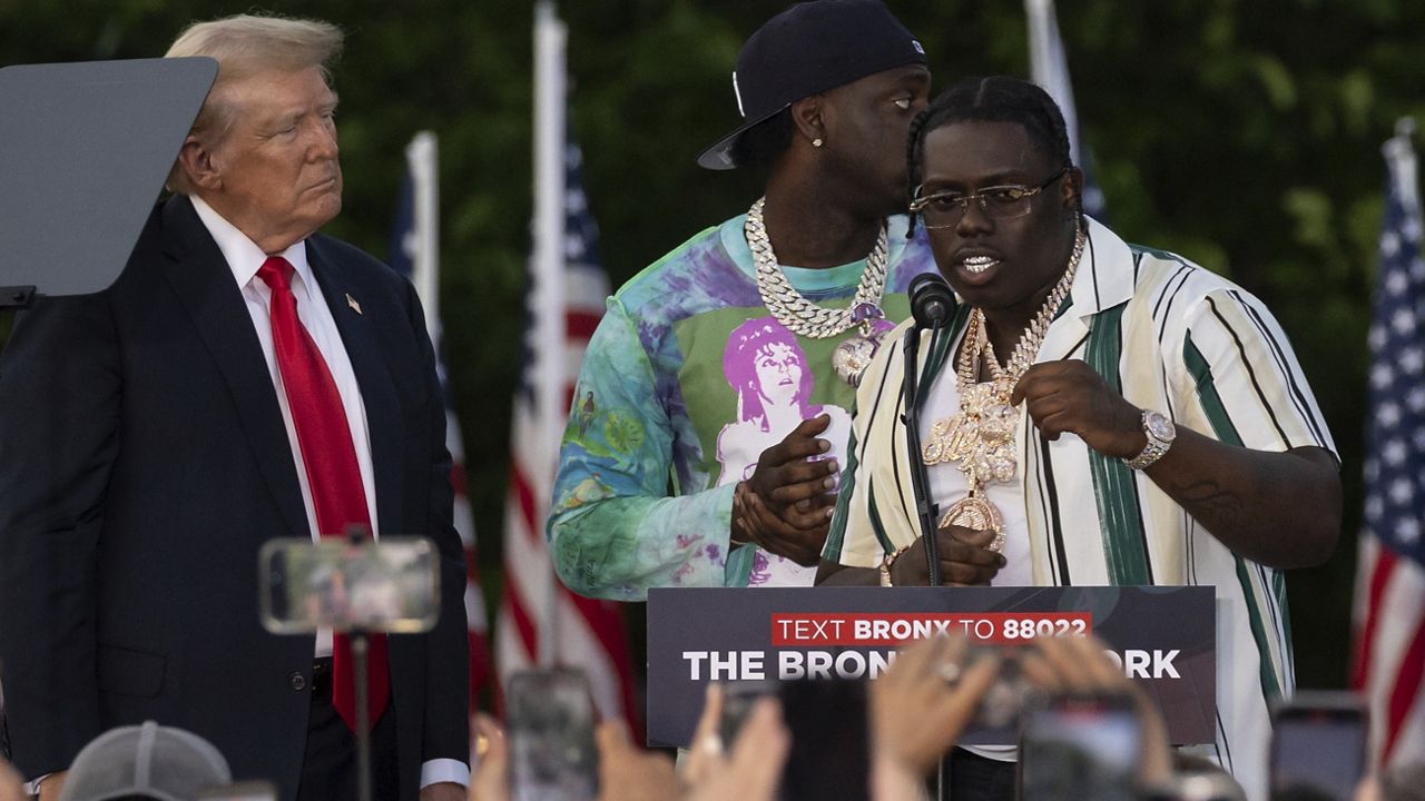 Rappers Sheff G, right, also known as Michael Williams, and Sleepy Hallow, center, also known as Tegan Chambers, join the Republican presidential candidate former President Donald Trump during a campaign rally in the south Bronx, Thursday, May. 23, 2024, in New York. (AP Photo/Yuki Iwamura)
