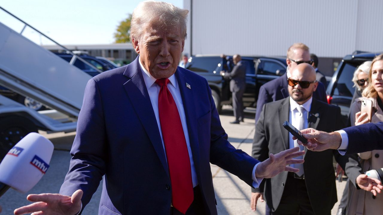 Republican presidential nominee former President Donald Trump speaks to reporters as he arrives at Detroit Metropolitan Wayne County Airport, Friday, Oct. 18, 2024, in Detroit. (AP Photo/Evan Vucci)