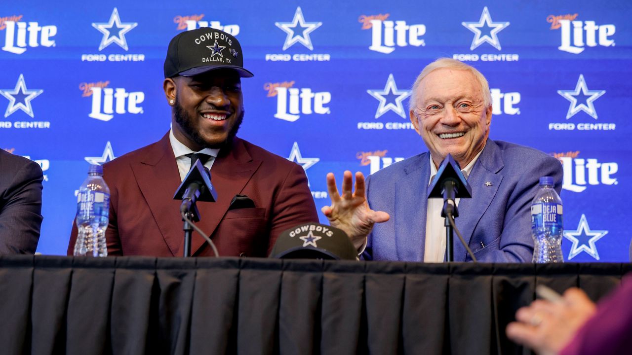 Dallas Cowboys first-round NFL football draft pick Tyler Booker, left, and team owner Jerry Jones, right, speak during a news conference in Frisco, Texas, Friday, April 25, 2025. (AP Photo/Gareth Patterson)