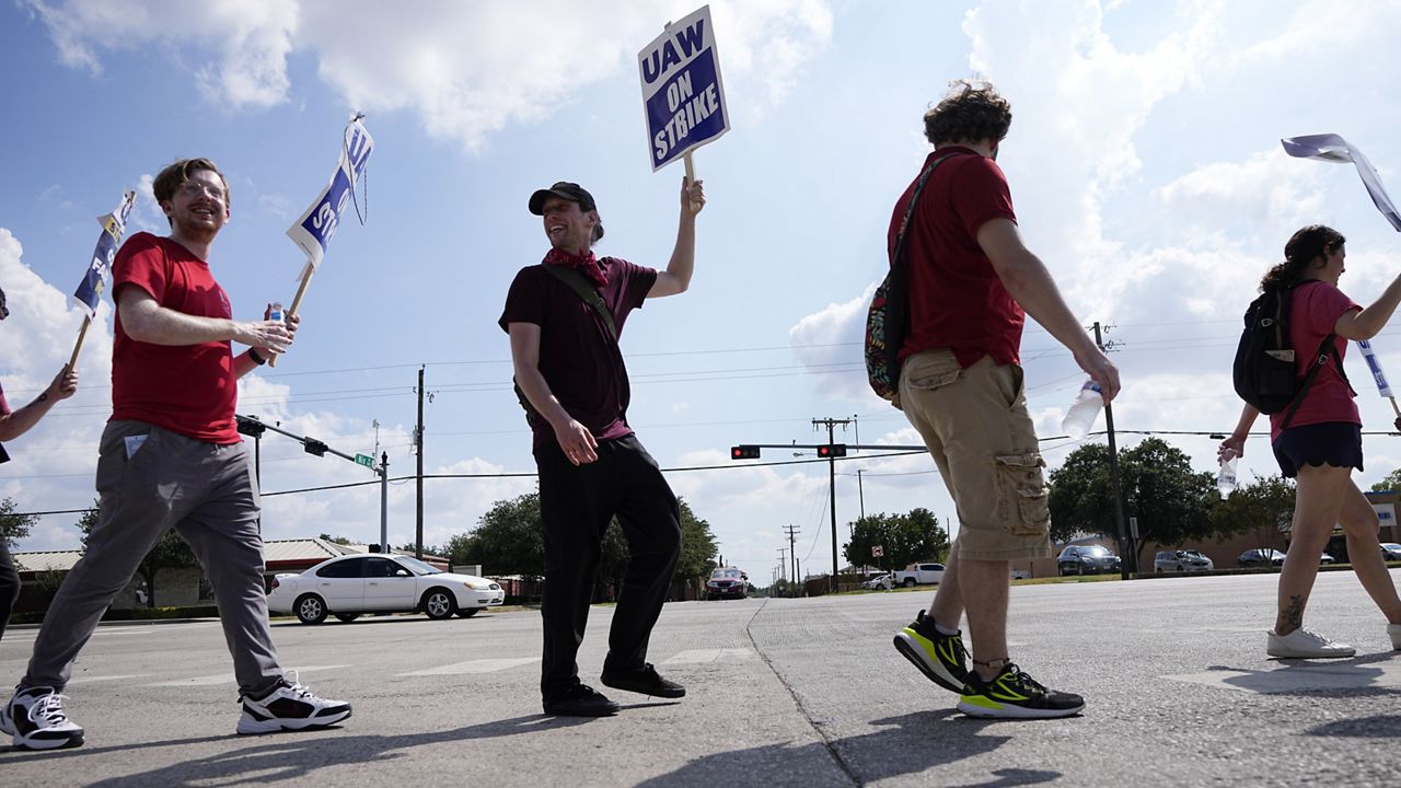 UAW union members picket on the street in front of a Stellantis distribution center, Monday, Sept. 25, 2023, in Carrollton, Texas. (AP Photo/Tony Gutierrez)