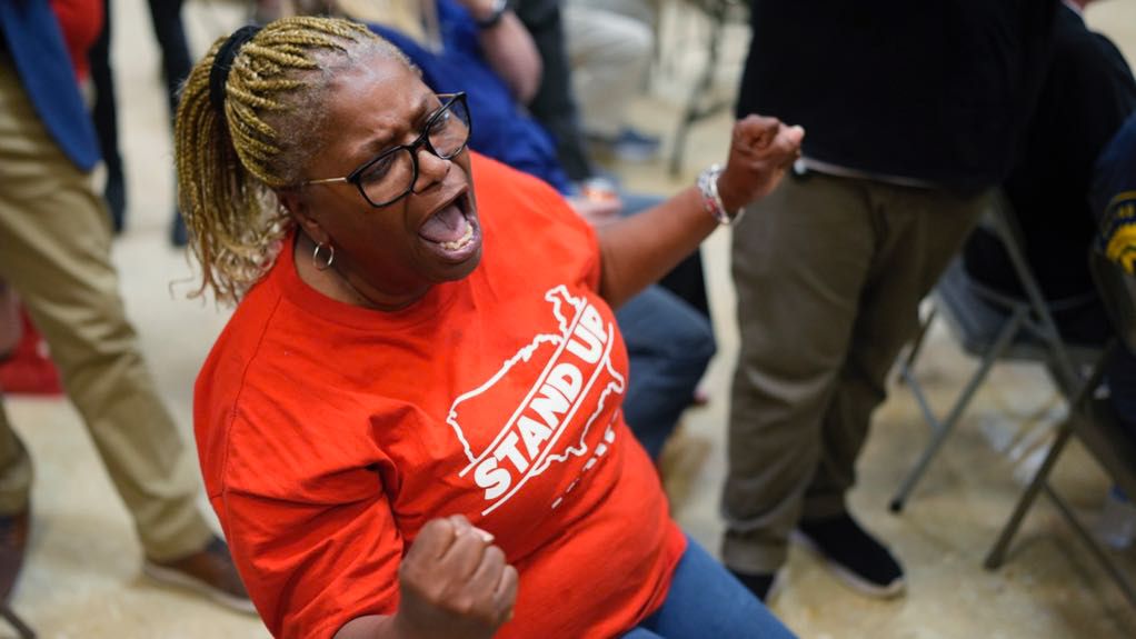Volkswagen automobile plant employee Vicky Holloway celebrates as she watches the results of a UAW union vote, late Friday, April 19, 2024, in Chattanooga, Tenn. (AP Photo/George Walker IV)