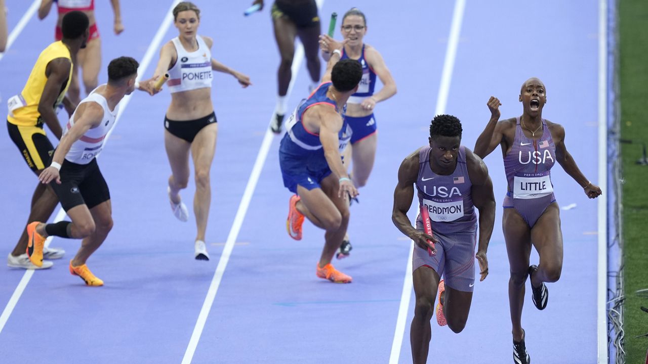 Shamier Little hands off to Bryce Deadmon, of the United States, during a heat in the 4 x 400-meter relay mixed at the 2024 Summer Olympics, Friday, Aug. 2, 2024, in Saint-Denis, France. (AP Photo/Martin Meissner)