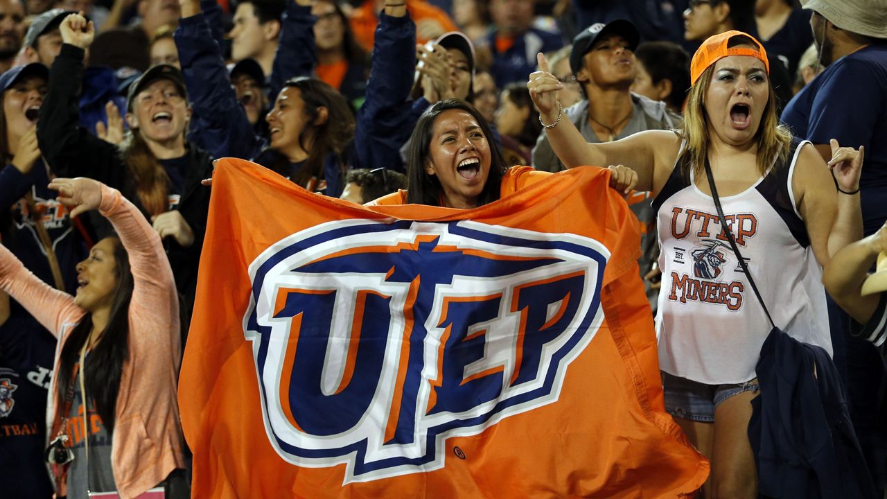 UTEP fans celebrate their team's victory 50-47 over New Mexico State in an NCAA college football game in Las Cruces, N.M., Saturday, Sept. 19, 2015. (AP Photo/Andres Leighton)