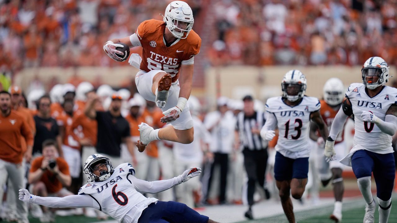 Texas tight end Gunnar Helm (85) leaps over UTSA safety Elliott Davison (6) during the first half of an NCAA college football game in Austin, Texas, Saturday, Sept. 14, 2024. (AP Photo/Eric Gay)