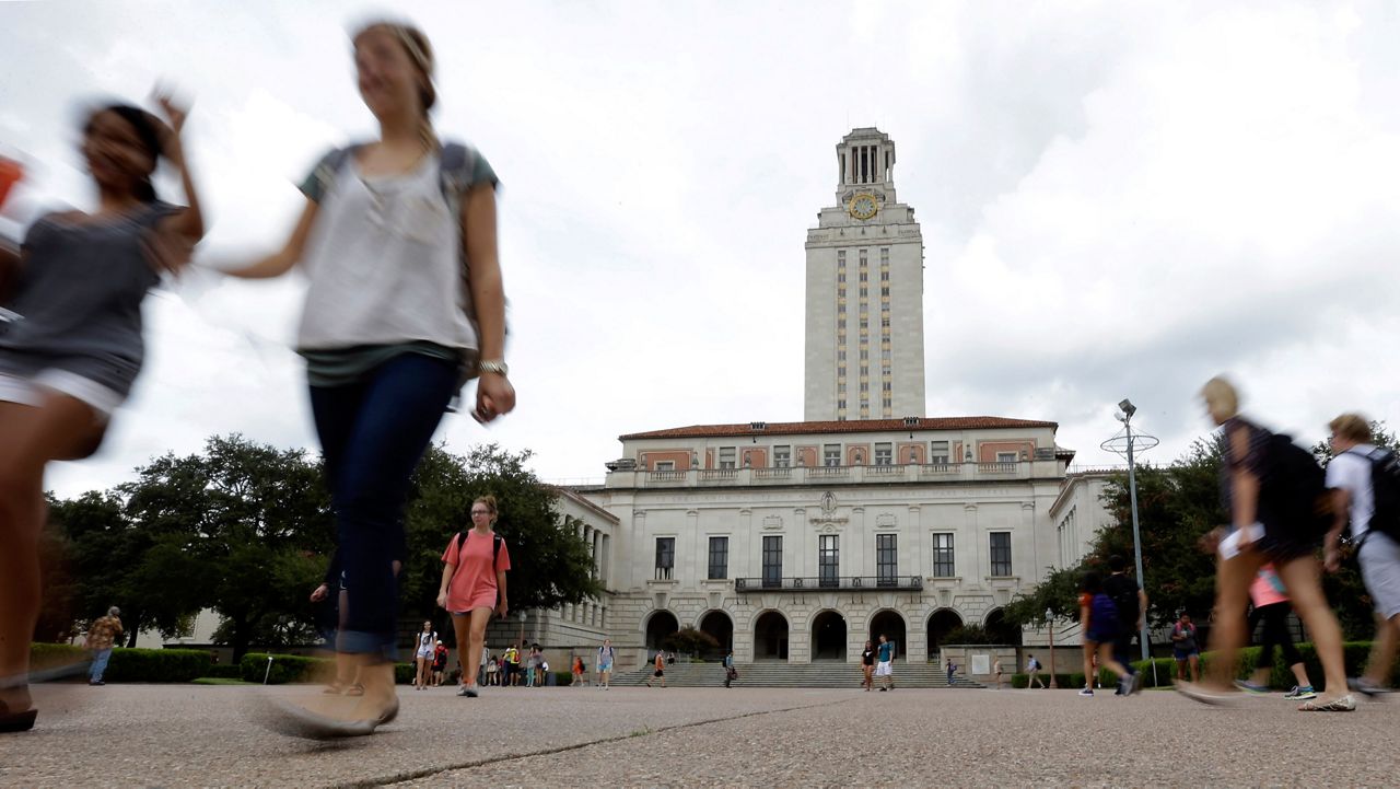 In this Sept. 27, 2012, file photo, students walk through the University of Texas at Austin campus near the school's iconic tower in Austin, Texas. (AP Photo/Eric Gay, File)