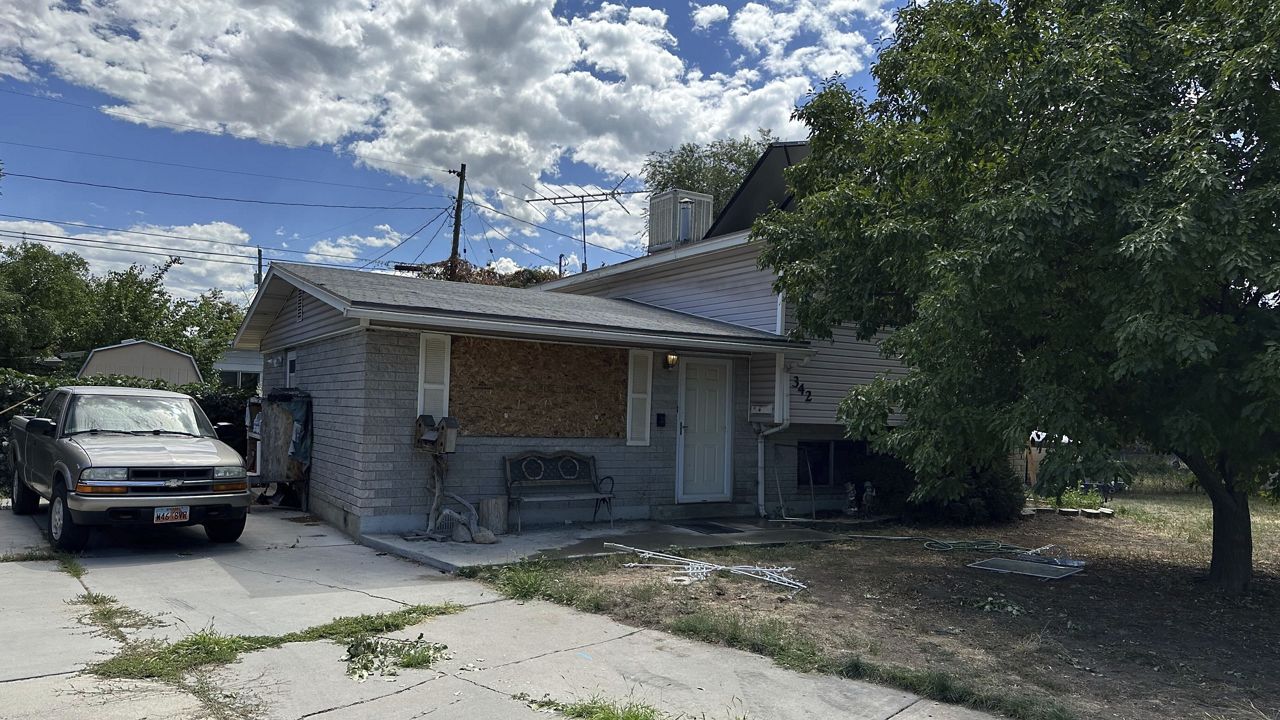 This photo shows a boarded up window and the front of the house of Craig Robertson, who was killed by FBI agents Wednesday during a confrontation after making violent threats against President Joseph Biden and other public officials, Thursday, Aug. 10, 2023 in Provo, Utah. (AP Photo/Sam Metz)