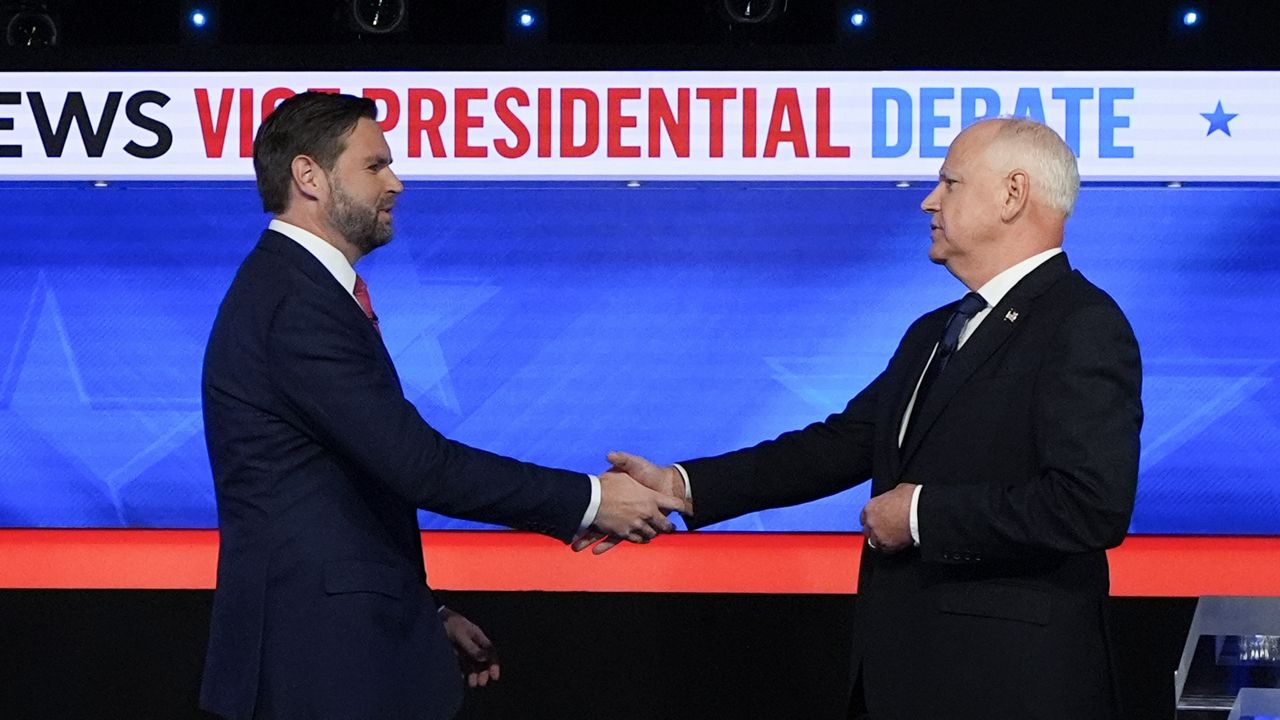 Republican vice presidential nominee Sen. JD Vance, R-Ohio, left, and Democratic vice presidential nominee Minnesota Gov. Tim Walz, shake hands as they arrive for a CBS News vice presidential debate, Tuesday, Oct. 1, 2024, in New York. (AP Photo/Julia Demaree Nikhinson)