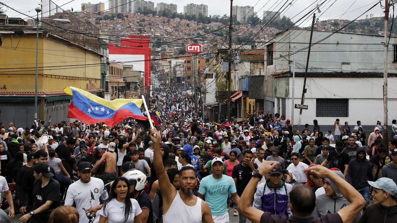 Protesters demonstrate against the official election results declaring President Nicolas Maduro won reelection in the Catia neighborhood of Caracas, Venezuela, Monday, July 29, 2024, the day after the vote. (AP Photo/Cristian Hernandez)