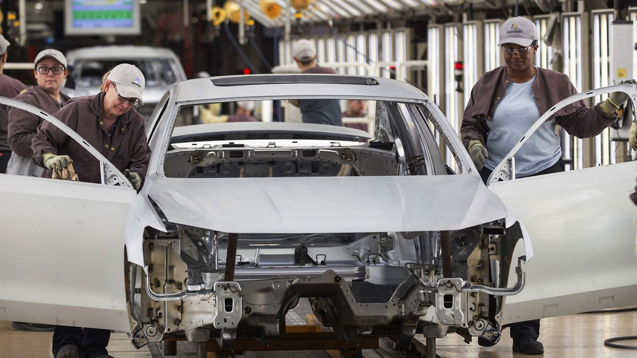 In this Aug. 31, 2017, file photo, workers produce vehicles at Volkswagen's U.S. plant in Chattanooga, Tenn. (AP Photo/Erik Schelzig)