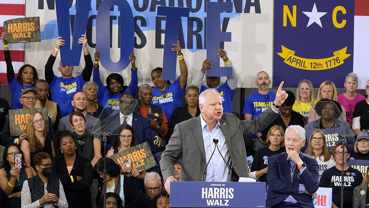 Democratic vice presidential nominee Minnesota Gov. Tim Walz appears with former President Bill Clinton at a campaign rally in Durham, N.C., Thursday, Oct. 17, 2024. (AP Photo/Steve Helber)