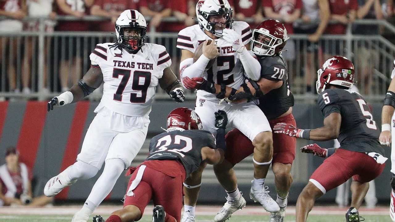 Washington State defensive back Tanner Moku (32) and edge Quinn Roff (20) tackle Texas Tech tight end Jalin Conyers (12) during the first half of an NCAA college football game, Saturday, Sept. 7, 2024, in Pullman, Wash. (AP Photo/Young Kwak)