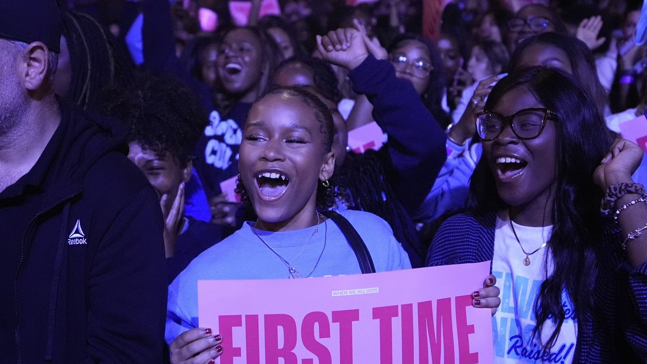 A first-time voter cheers before former first lady Michelle Obama speaks at campaign rally in support of Democratic presidential nominee Vice President Kamala Harris, Tuesday, Oct. 29, 2024, in College Park, Ga. (AP Photo/Brynn Anderson)