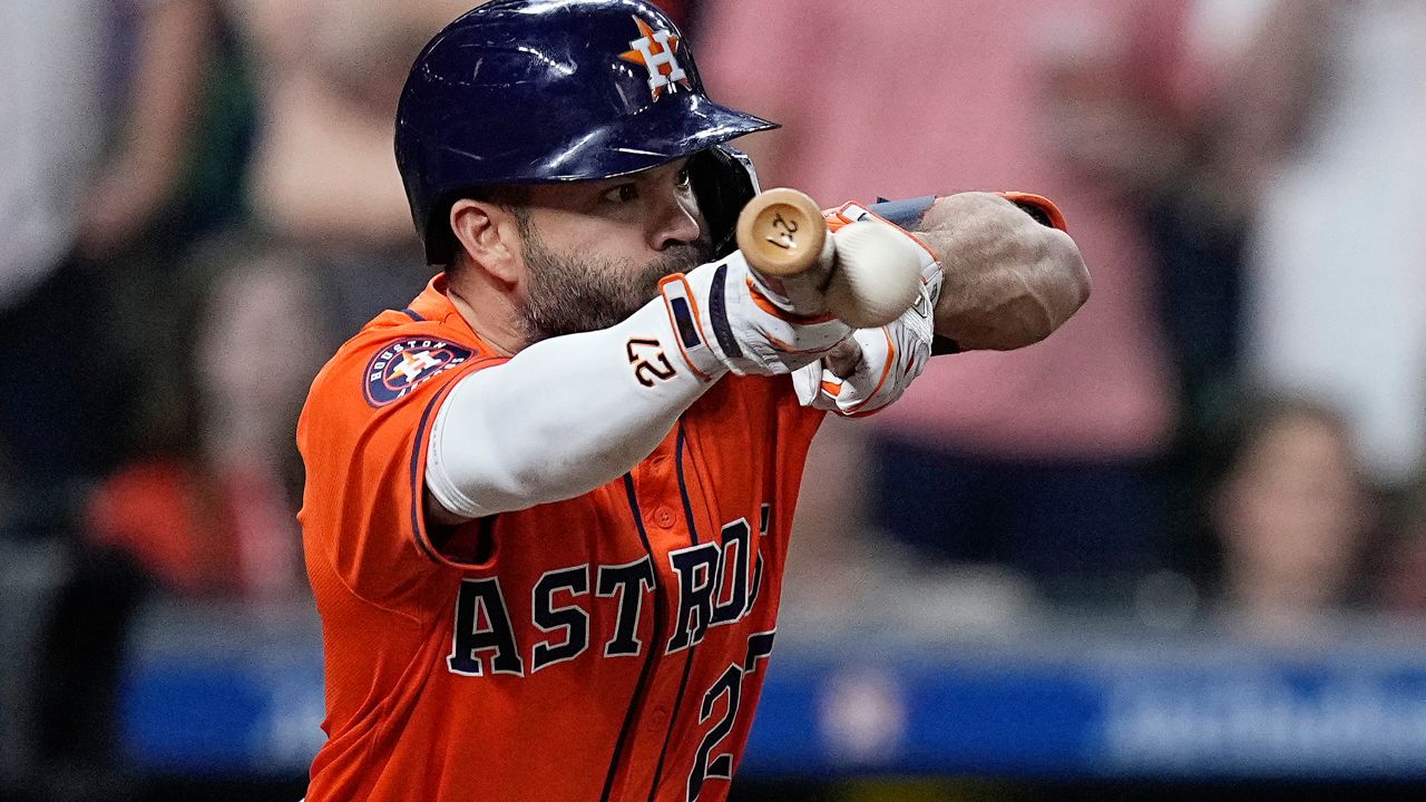Houston Astros' Jose Altuve hits an RBI bunt single during the seventh inning of a baseball game against the Seattle Mariners Friday, May 3, 2024, in Houston. (AP Photo/Kevin M. Cox)
