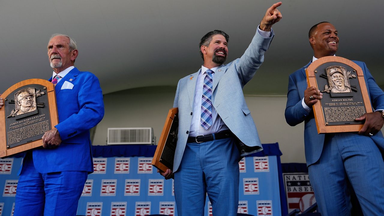 Baseball Hall of Fame inductees Jim Leyland, left, Todd Helton, center, and Adrián Beltré, right, holds their plaques at the National Baseball Hall of Fame induction ceremony, Sunday, July 21, 2024, in Cooperstown, N.Y. (AP Photo/Julia Nikhinson)