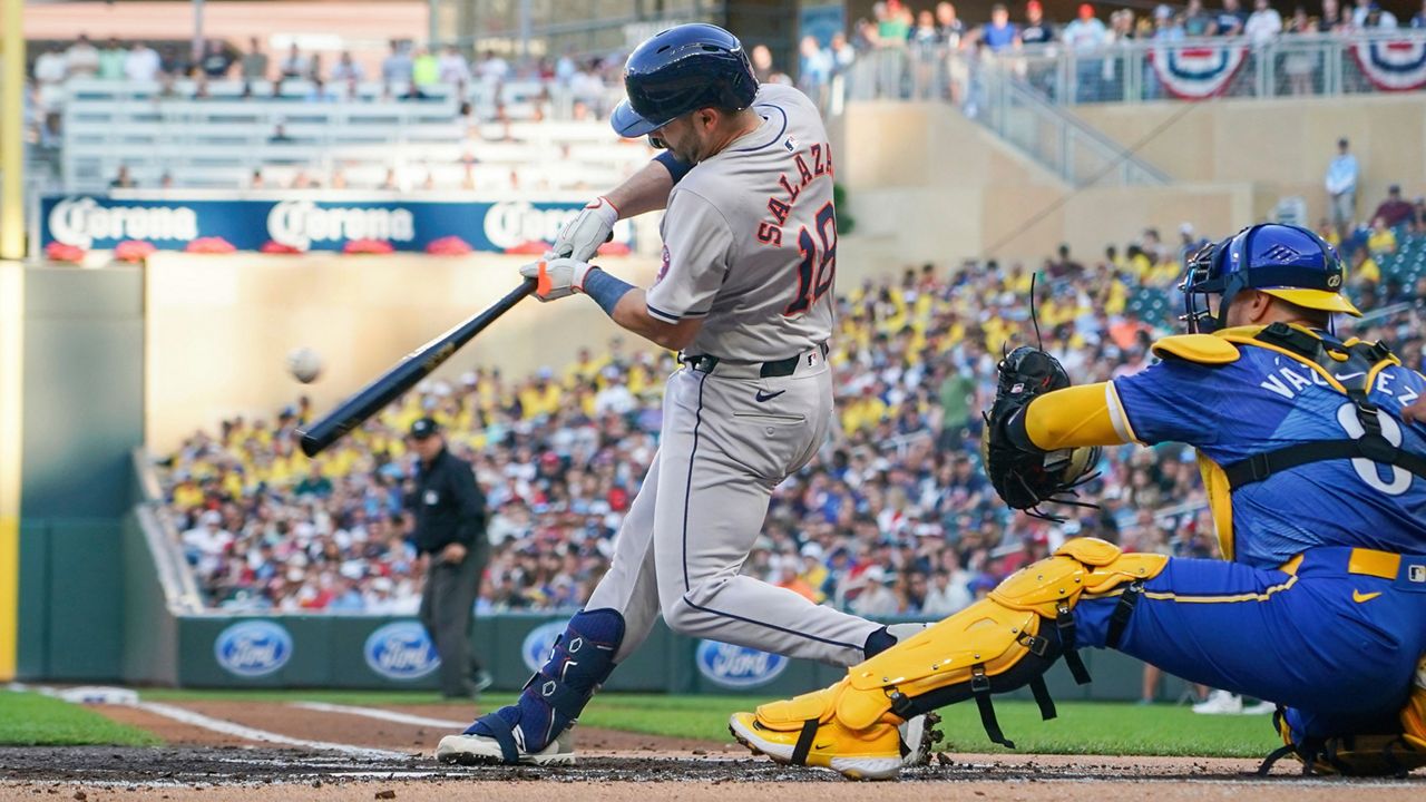 Houston Astros' Cesar Salazar (18) hits an RBI single, scoring Jonathan Singleton, as Minnesota Twins catcher Christian Vazquez (8) looks on during the second inning of a baseball game Friday, July 5, 2024, in Minneapolis. (AP Photo/Craig Lassig)