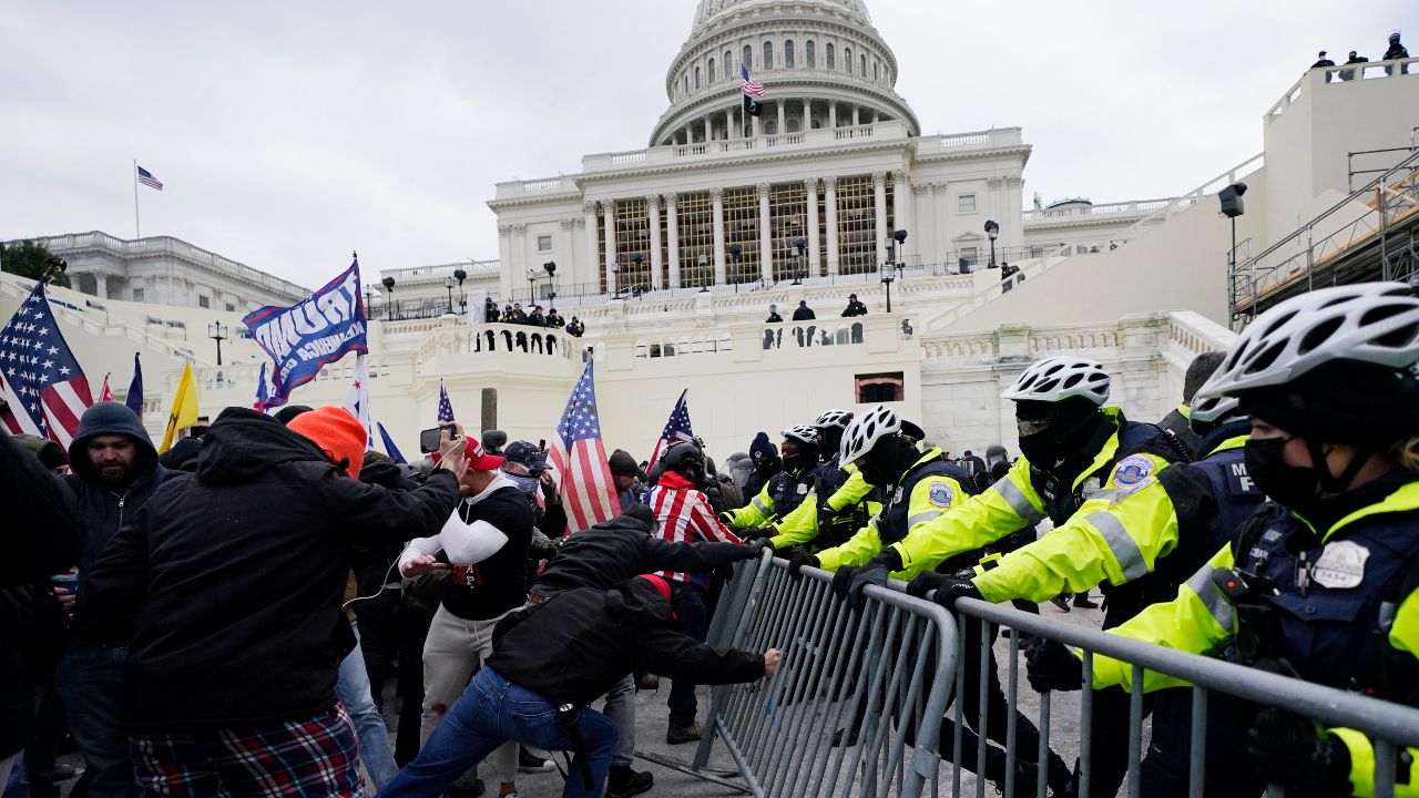 Insurrectionists loyal to President Donald Trump try to break through a police barrier, Wednesday, Jan. 6, 2021, at the Capitol in Washington. (AP Photo/Julio Cortez)