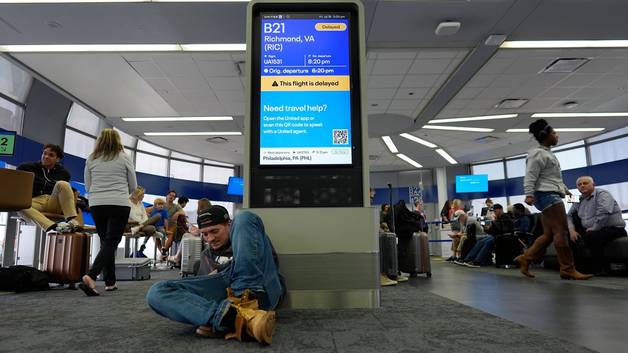 An information display near United gates shows a flight delay at Chicago O'Hare International Airport in Chicago, Friday, July 19, 2024, after software issues delayed and canceled flights globally. (AP Photo/Carolyn Kaster)