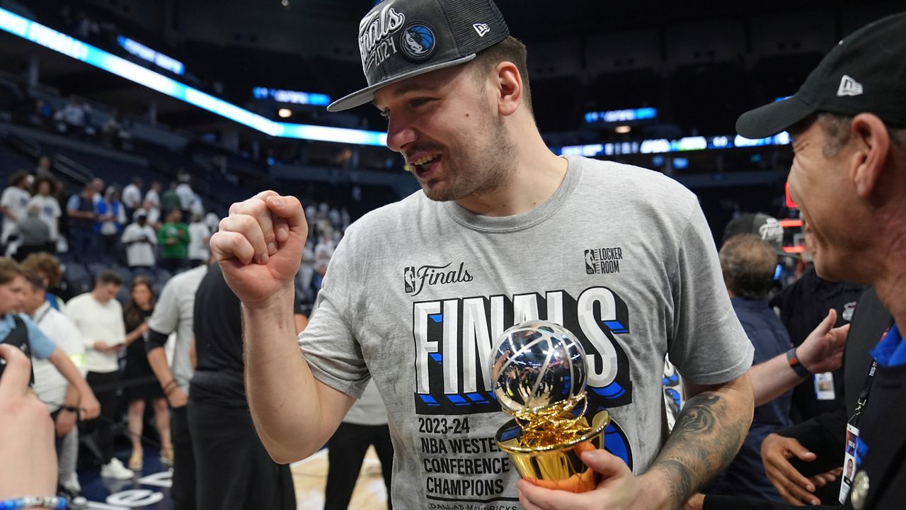 Dallas Mavericks guard Luka Doncic celebrates the team's win over the Minnesota Timberwolves in Game 5 of the Western Conference finals in the NBA basketball playoffs Thursday, May 30, 2024, in Minneapolis. The Mavericks won 124-103, taking the series 4-1 and moving on to the NBA Finals. (AP Photo/Abbie Parr)