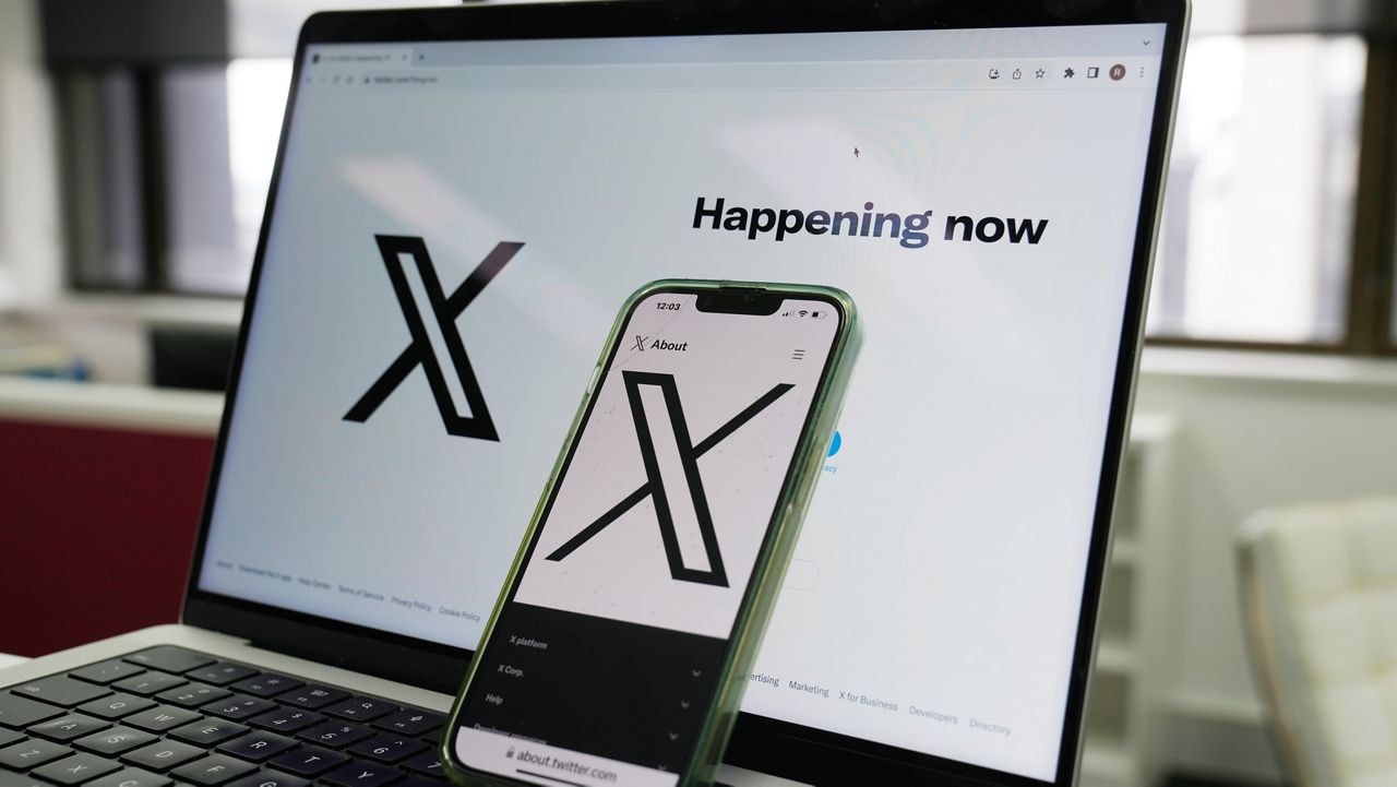 The opening page of X is displayed on a computer and phone, Oct. 16, 2023, in Sydney. (AP Photo/Rick Rycroft)