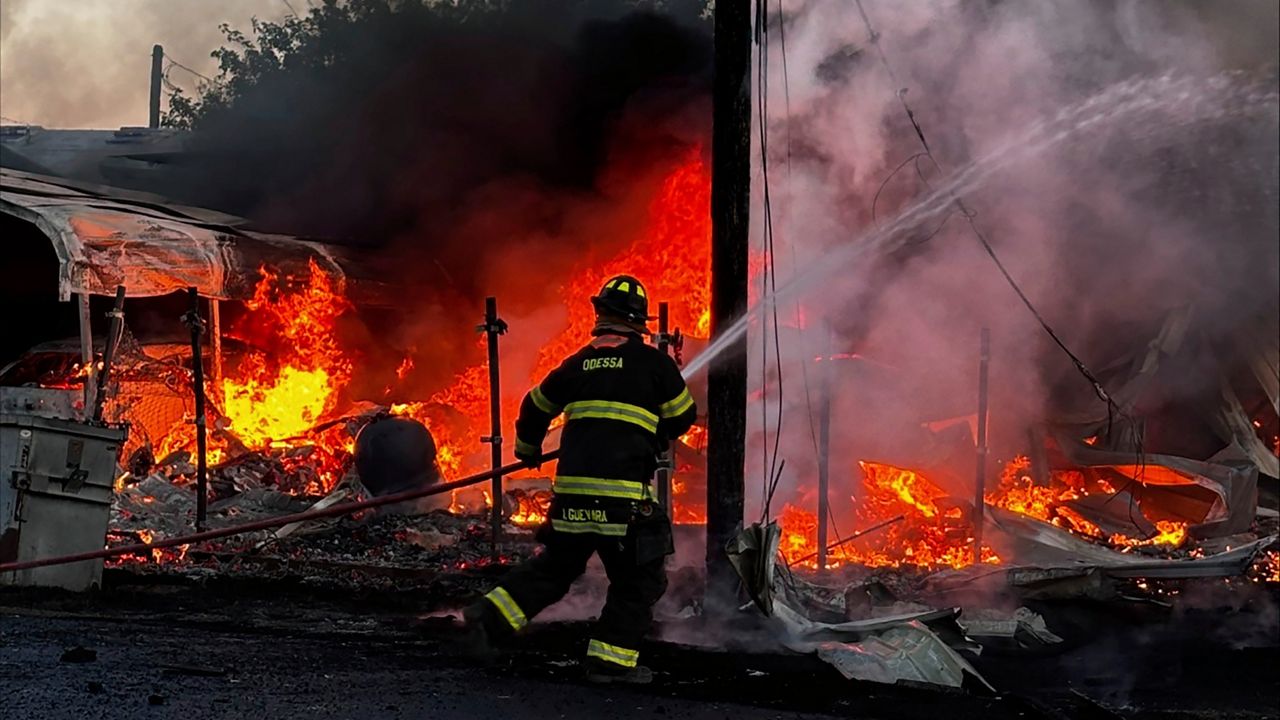 This image provided by Mark Matta shows a firefighter working on the scene of a plane crash in Odessa, Texas, Tuesday, Aug. 20, 2024. (Mark Matta via AP)