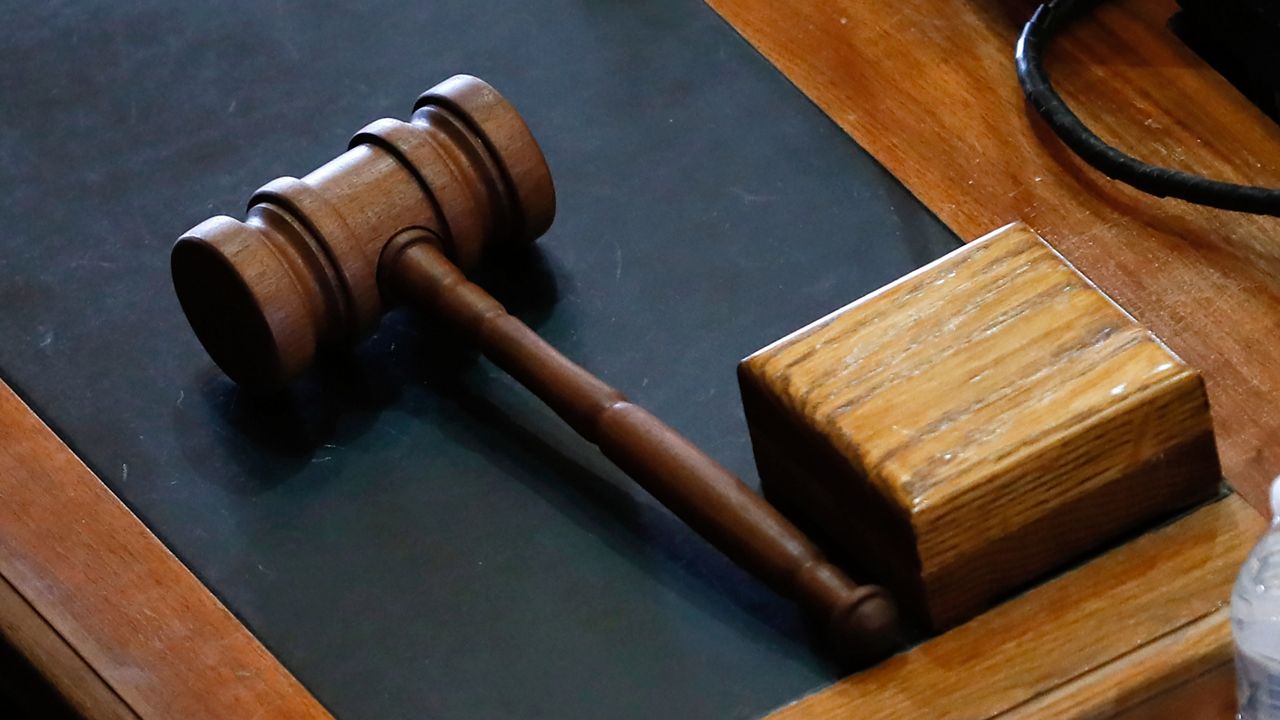 A gavel sits on a desk.