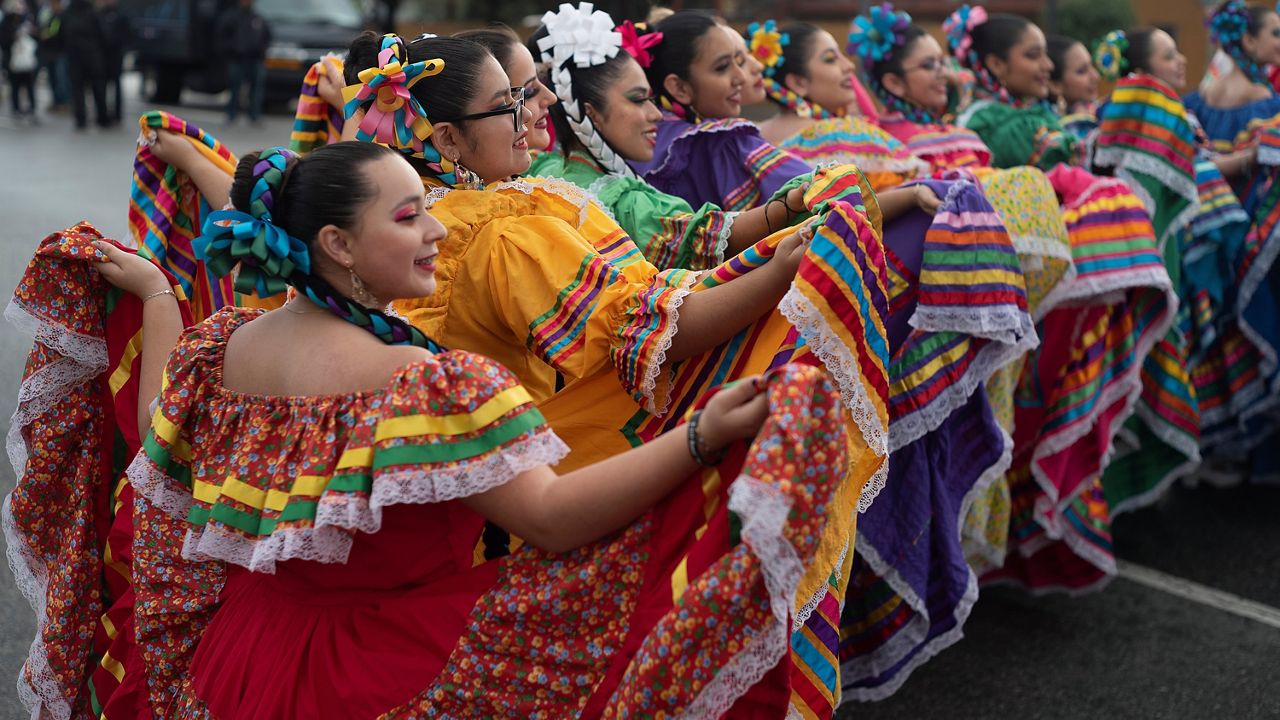 Members of the Cathedral City High School Ballet Folklorico pose for photo prior to joining in the Kingdom Day Parade in Los Angeles, Jan. 16, 2023. (AP Photo/Richard Vogel, File)