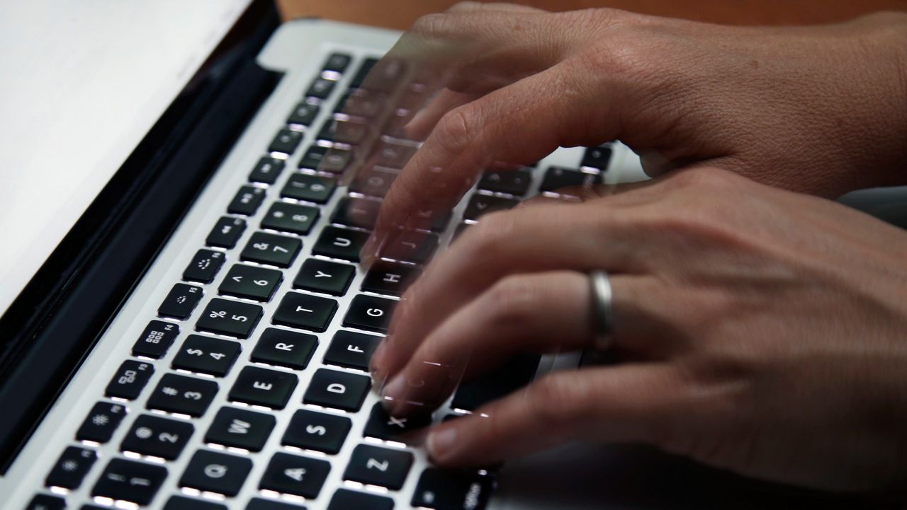 This June 19, 2017 file photo shows a person working on a laptop in North Andover, Mass. (AP Photo/Elise Amendola, File)