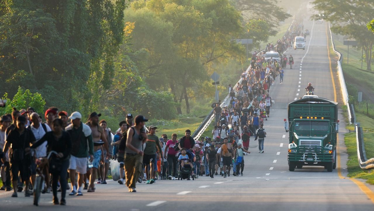 Migrants walk along the highway in Huixtla, southern Mexico, heading toward the country's northern border and ultimately the United States, Thursday, Nov. 7, 2024. (AP Photo/Moises Castillo)