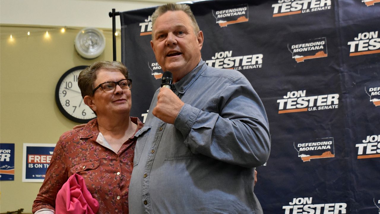 U.S. Sen. Jon Tester, D-Mont., speaks while standing next to his wife, Sharla, at a campaign rally, Thursday, Sept. 5, 2024, in Bozeman, Mont. (AP Photo/Matthew Brown) 