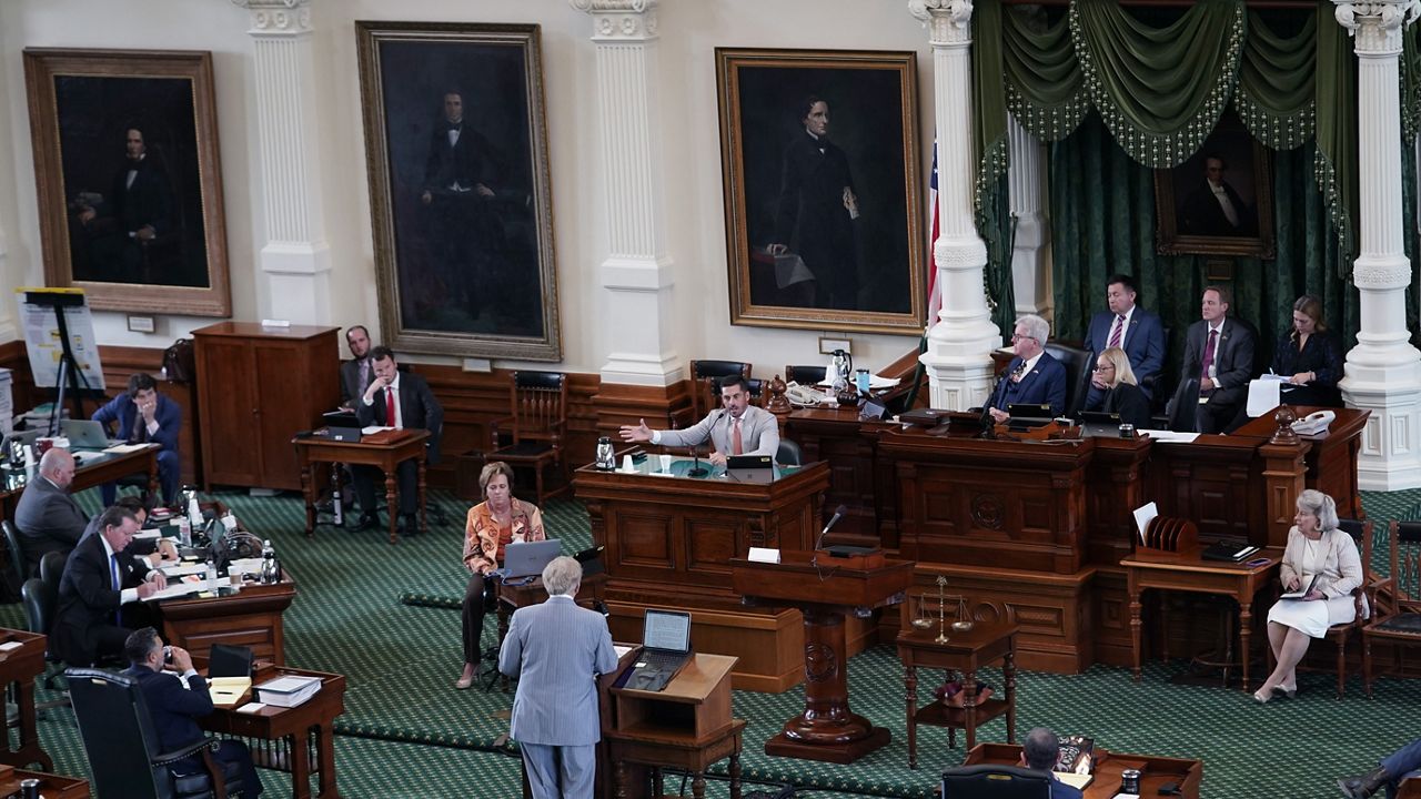 Texas Lt. Gov. Dan Patrick, seated center, talks to prosecution and defense attorneys after the prosecution rested in the impeachment trial for Texas Attorney General Ken Paxton in the Senate Chamber at the Texas Capitol, Wednesday, Sept. 13, 2023, in Austin, Texas. (AP Photo/Eric Gay)