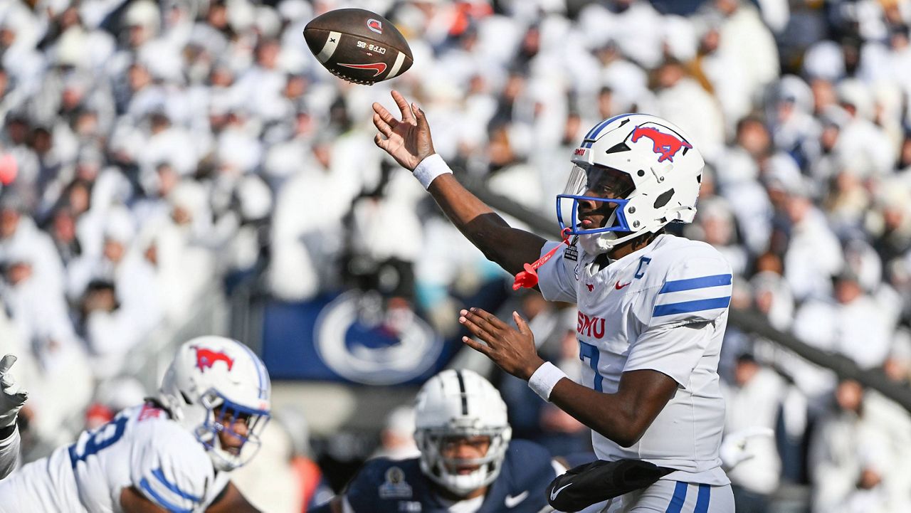 SMU quarterback Kevin Jennings (7) throws a pass while being pressured by Penn State linebacker Kobe King #41 during the first half in the first round of the NCAA College Football Playoff, Saturday, Dec. 21, 2024, in State College, Pa. (AP Photo/Barry Reeger)