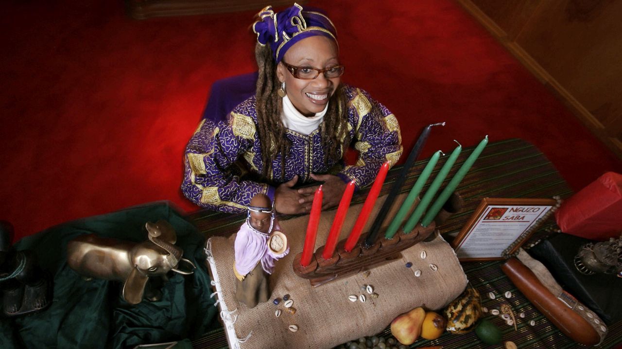 This photo taken Dec. 8, 2009 shows Ruth Ndiagne Dorsey with a Kwanzaa setting set up for a media photo at her church, The Shrine of the Black Madonna, in Atlanta. (AP Photo/John Amis)