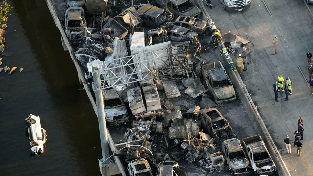 In this aerial photo, responders are seen near wreckage in the aftermath of a multi-vehicle pileup on I-55 in Manchac, La., Monday, Oct. 23, 2023. A “superfog” of smoke from south Louisiana marsh fires and dense morning fog caused multiple traffic crashes involving scores of cars. (AP Photo/Gerald Herbert)