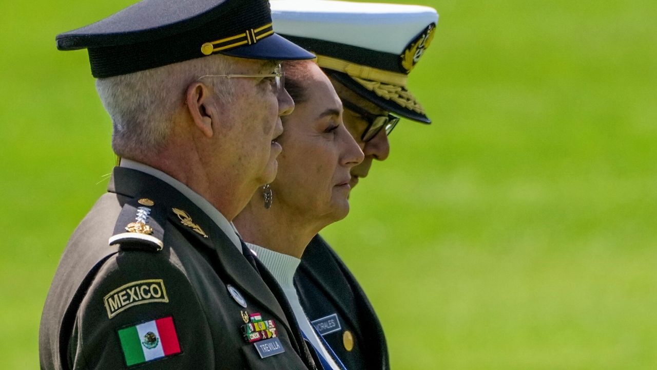 Mexican President Claudia Sheinbaum, center, reviews the troops with Defense Minister Gen. Ricardo Trevilla Trejo, left, and Navy Secretary Alt. Raymundo Pedro Morales, at Campo Marte in Mexico City, Oct. 3, 2024. (AP Photo/Fernando Llano, File)