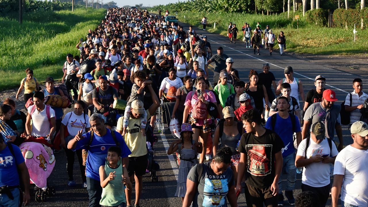 Migrants walk along the highway through Suchiate, Chiapas state in southern Mexico, Sunday, July 21, 2024, during their journey north toward the U.S. border. (AP Photo/Edgar H. Clemente)