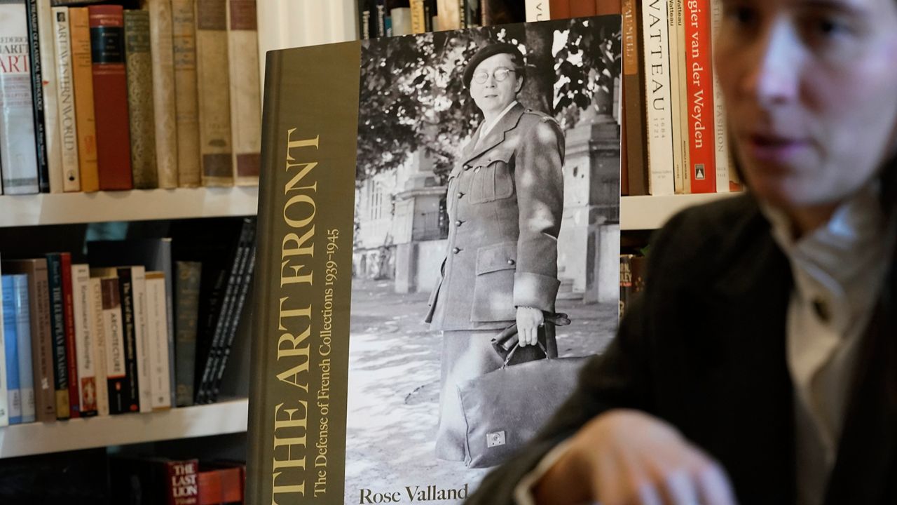 A mockup of a book by Rose Valland satnds in the background during an interview with Anna Bottinelli, head of the Monuments Men and Women Foundation, in Dallas, Monday, Dec. 11, 2023. With the foundation's help Valland's book will be the first English translation of a the Monuments Woman work. (AP Photo/LM Otero)