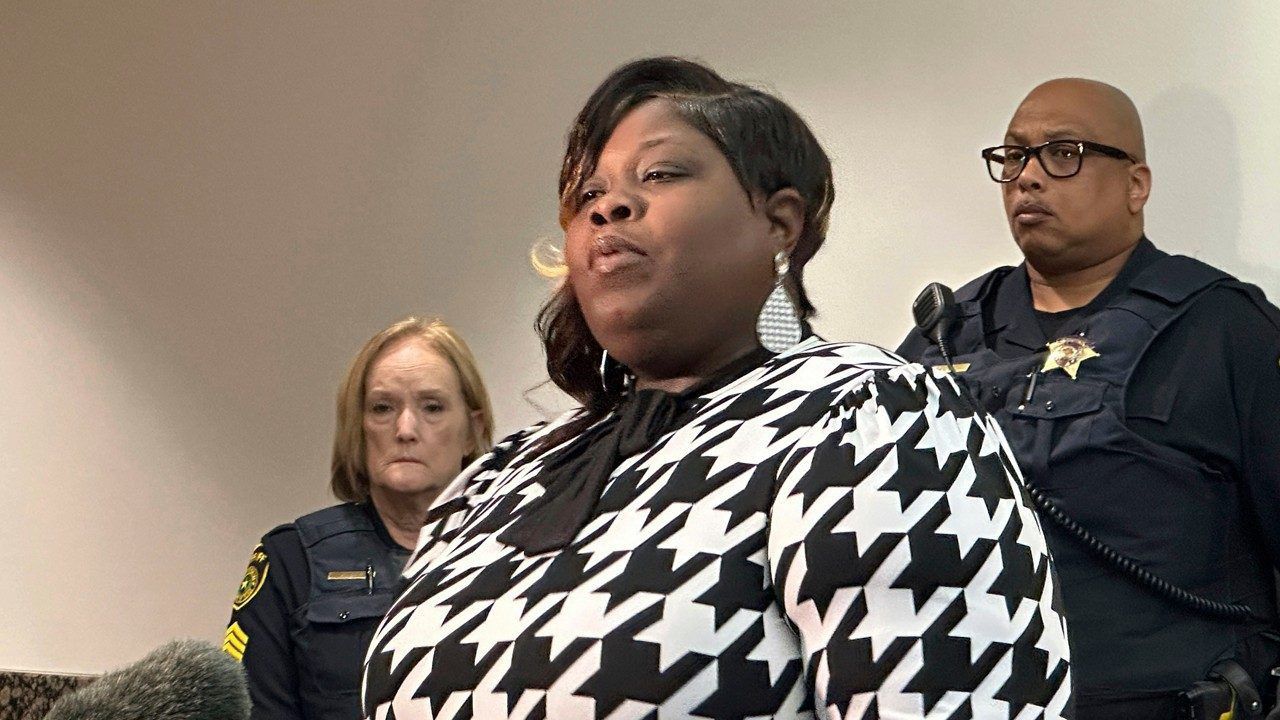 Stephanie Houston holds a photo of her daughter Muhlaysia Booker as she speaks to reporters on Thursday, Nov. 9, 2023, after giving a victim impact statement in a courtroom at the Frank Crowley Courts Building in Dallas. On Monday, Nov. 6, Kendrell Lyles pleaded guilty to murder in the death of Booker, a 22-year-old transgender woman who was fatally shot in 2019. Lyles was sentenced to 48 years in prison. (AP Photo/Jamie Stengle)