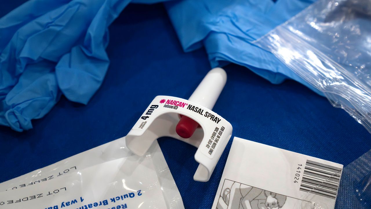 A container of Narcan, a brand name version of the opioid overdose-reversal drug naloxone, sits on a table. (AP Photo/Mark Schiefelbein)