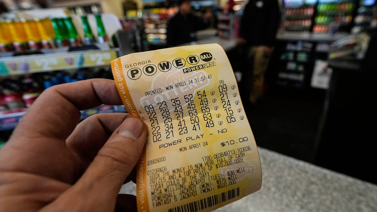 A Powerball lottery ticket is dipslayed seen inside a convenience store, Monday, April 1, 2024, in Kennesaw, Ga. (AP Photo/Mike Stewart, File)
