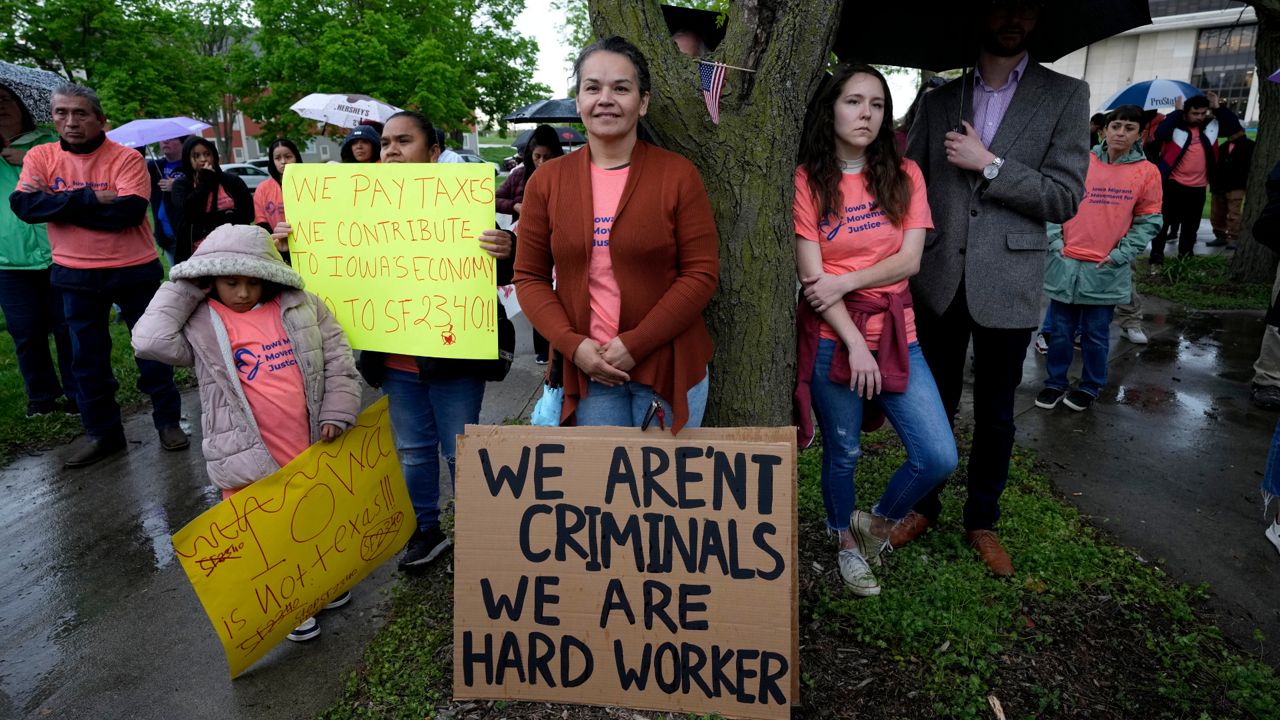 People listen to a speaker during an Iowa Movement for Migrant Justice rally and march, Wednesday, May 1, 2024, in Des Moines, Iowa. (AP Photo/Charlie Neibergall)